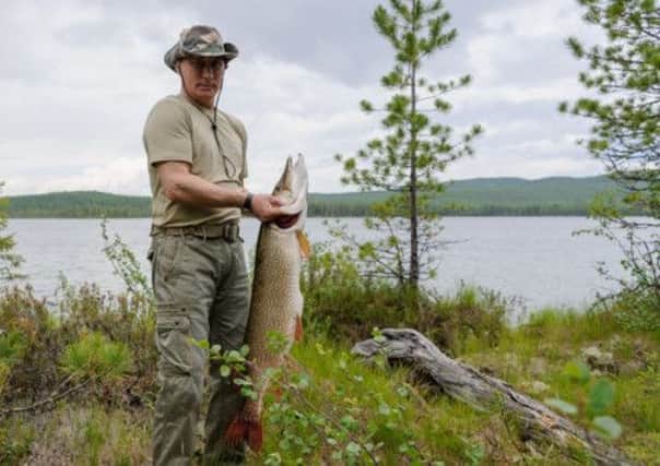 Vladimir Putin pictured with what is reportedly the huge pike. Picture: AFP