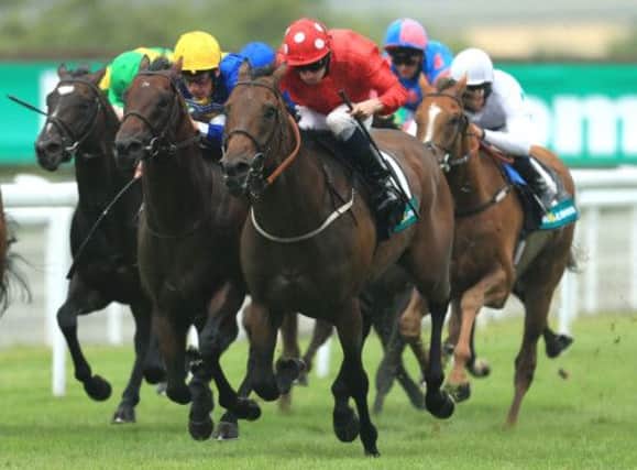 Garswood, red colours, takes the Lennox Stakes by the scruff of the neck. Picture: PA