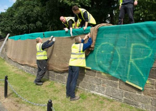 Vandals daubbed graffiti on the boundary walls of Holyrood Palace. Picture: Joey Kelly