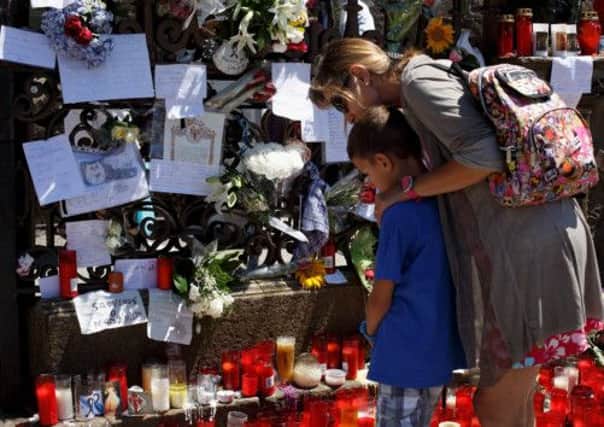 Messages, flowers and candles left in memory of the victims of the July 24 train crash. Picture: Getty