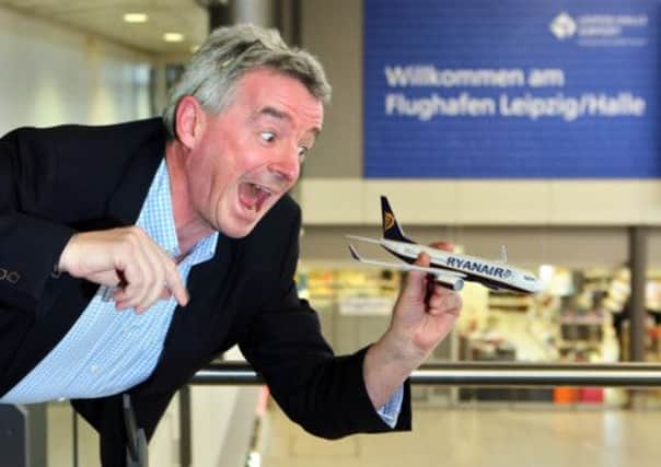 Michael O'Leary horses around with a model aeroplane at Leipzig Airport in Germany. Picture: AFP