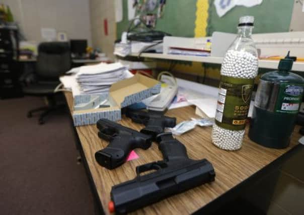 Practice guns sit on an Arkansas teacher's desk. Picture: AP