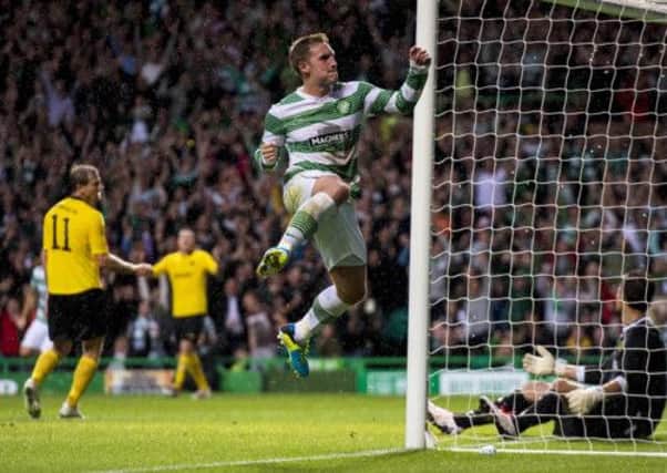 Celtic's Kris Commons jumps for joy after opening the scoring. Picture: SNS