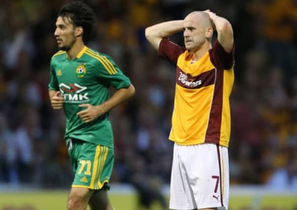 Motherwell's James McFadden next to Kuban Krasnodar goal scorer Ivelin Popov. Picture: PA