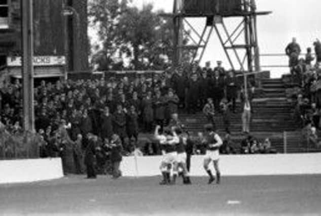 A huge police presence as the Hibs team celebrate a goal in 1975