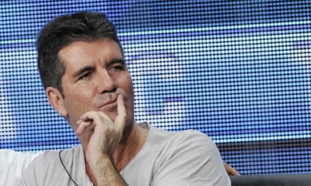 Cowell was questioned about widespread reports he is expecting his first child with New York socialite Lauren Silverman. Picture: AP
