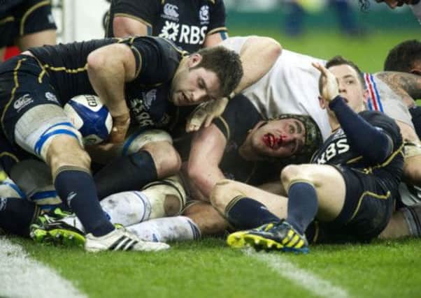 Scotland's Kelly Brown emerges blooded from the scrum. Picture: SNS