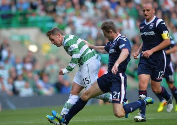 Kris Commons of Celtic and Brian McLean of Ross County clash in the box. Picture: Getty
