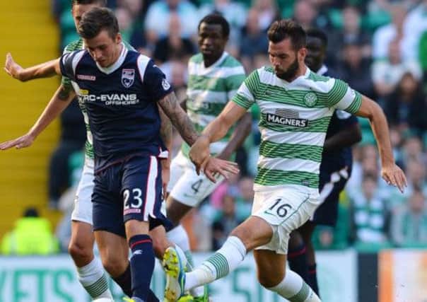 Joe Ledley challenges Graham Carey of Ross County during Celtic's 2-1 Premiership victory at Parkhead on Saturday. Picture: Getty