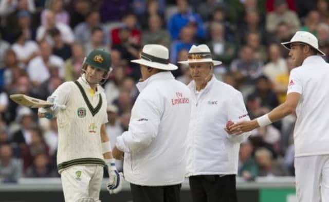 Australia captain Michael Clarke makes his point to the unpires after the decision to go off for bad light. Picture: AP