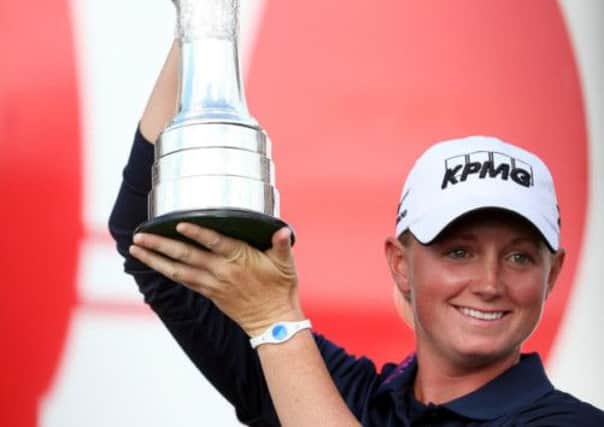 Stacy Lewis lifts the trophy after her victory in the Women's British Open at St Andrews. Picture: AP