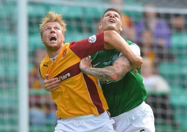 Michael Nelson challenges Motherwell's Henri Anier during his debut for Hibs on Sunday. Picture: Getty