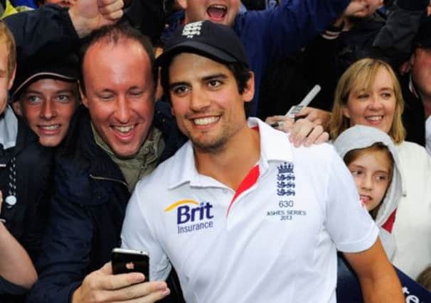 England captain Alastair Cook shares in the celebrations of the fans at Old Trafford yesterday.  Picture: Getty