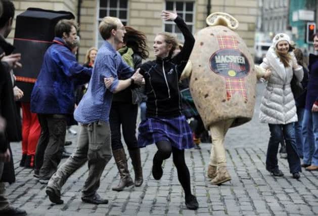 Members of a flash mob in Edinburgh show that dancing is meant to be fun. Picture: Phil Wilkinson