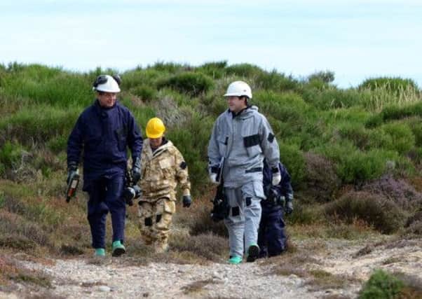 Chemical Ordinance Specialists from BAE systems carry out radioactive testing. Picture: HeMedia