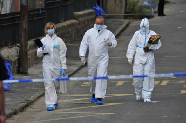 Police and forensics attend the scene of a double shooting tragedy in East Kilbride. Picture: Robert Perry