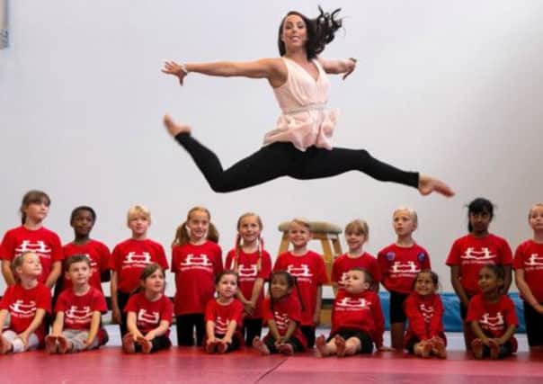 Beth Tweddle teaches pupils how it's done at Chobham Academy on the Olympic site, where she announced her retirement. Picture: Getty