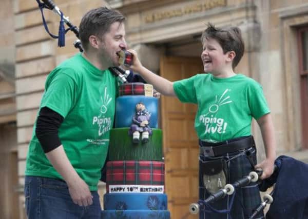 Piping star Ruari Buchan, who will turn 10-years-old this year, shares his birthday cake with Finlay MacDonald. Picture: Chris James