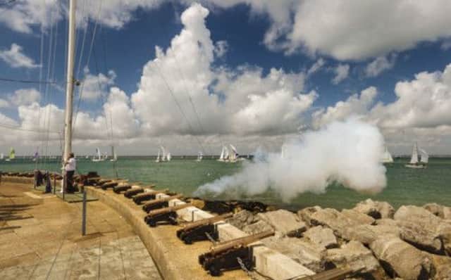 A cannon fires outside the Royal Yacht Squadron in Cowes to signal a passing yacht winning its class during Cowes Week. Picture: PA