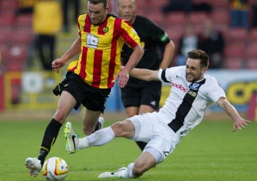 Christie Elliott, left, tries to make his way past Ayr Utd's Adam Hunter. Picture: SNS