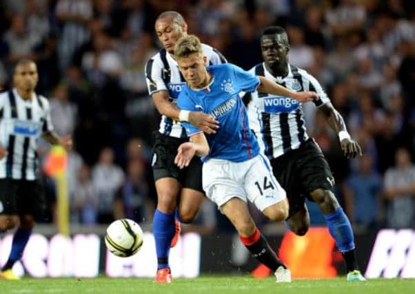 Andy Murdoch causes problems for Yoan Gouffran, left, and Cheik Tiote. Picture: SNS