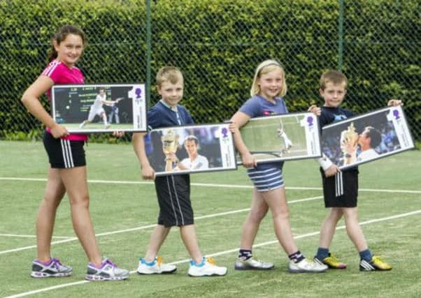 From left to right: Emma Johnston, 10, Wallace McInnes, nine, Bethan Clark, eight,and Euan Anderson, nine, unveil the stamps. Picture: PA