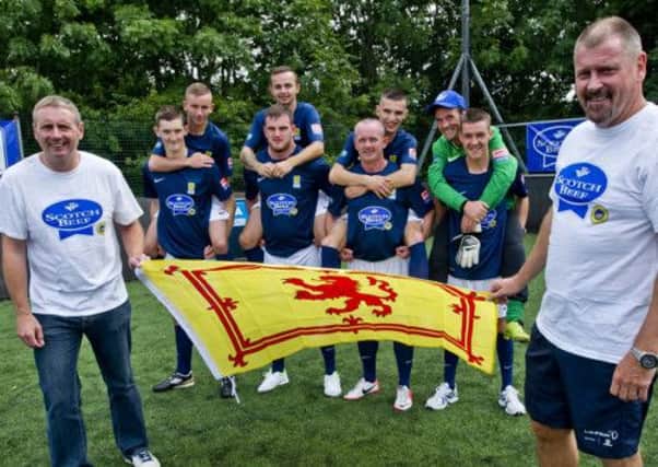 The Scottish Homeless World Cup squad prepare to set off for Poland, flanked by Tom Boyd and Ali Dawson. Picture: Alan Peebles