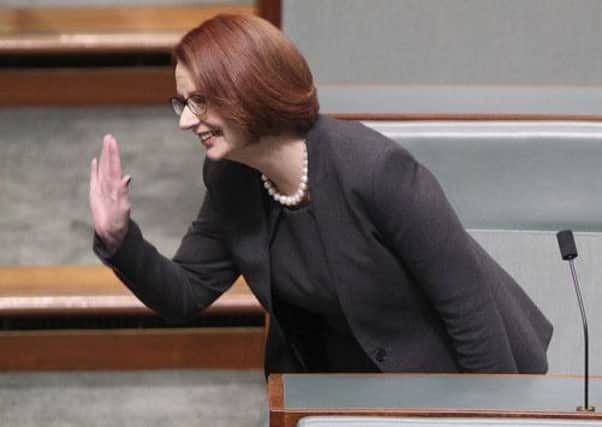 Julia Gillard waves as she takes her seat in the House of Representatives. Picture: Getty
