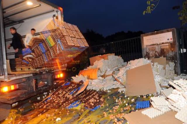 A farmer dumps crates of eggs from the back of a lorry on to the pavement in front of the tax office in Carhaix. Picture: Getty