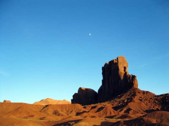 A late fall moon as it rises over sandstone formations in Monument Valley. Picture: AP