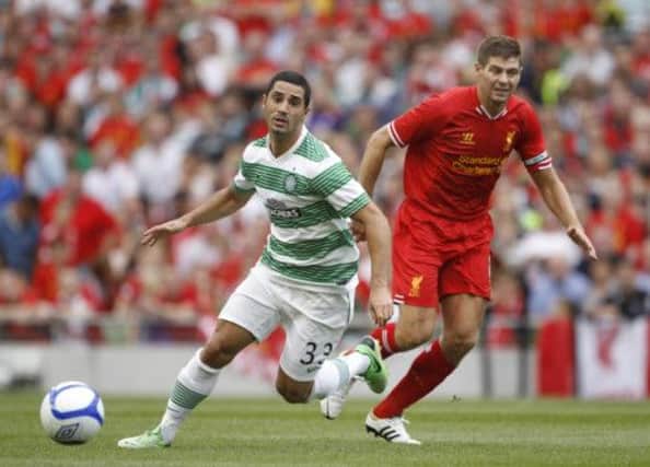 Celtic's Beram Kayal, left, wins the ball from Liverpool's Steven Gerrard. Picture: AP