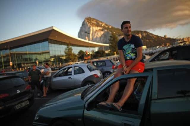 Drivers wait to enter to Spain at its border with Gibraltar in front of the International airport and the rock. Picture: Reuters