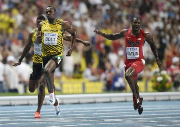 Usain Bolt crosses the line ahead of Justin Gatlin of the US  to win the mens 100 metres final in Moscow last night. Picture: Reuters