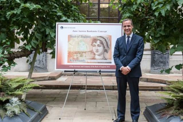 Mark Carney with the ten pound note featuring Jane Austen. Picture: PA