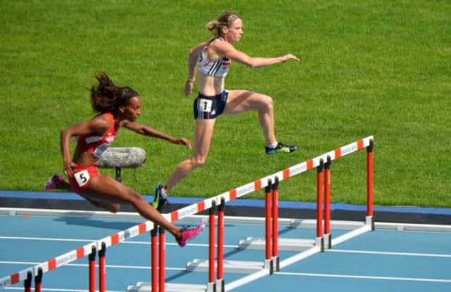 Dalilah Muhammad of the USA leads, just ahead of Great Britains Eilidh Child, in yesterdays 400m hurdles heat in Moscow. Picture: AFP/Getty