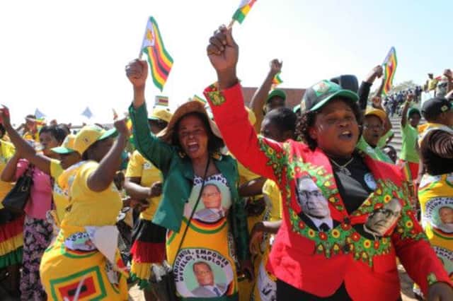 Supporters of presidentelect Robert Mugabe sing and dance during a Heroes Day celebration in Harare. Picture: Tsvangirayi Mukwazhi/AP