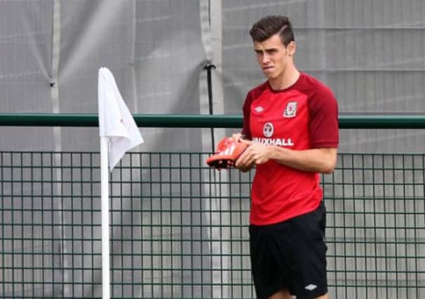 Gareth Bale trained yesterday but wont be needing his boots for tomorrows friendly in Cardiff. Picture: PA