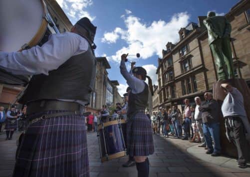 Members of the Cowal pipe band performing on Buchanan Street, Glasgow. Picture: Chris James