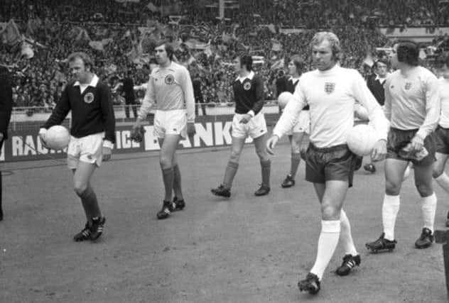 Captains Billy Bremner and Bobby Moore lead their teams out in 1973. Picture: TSPL