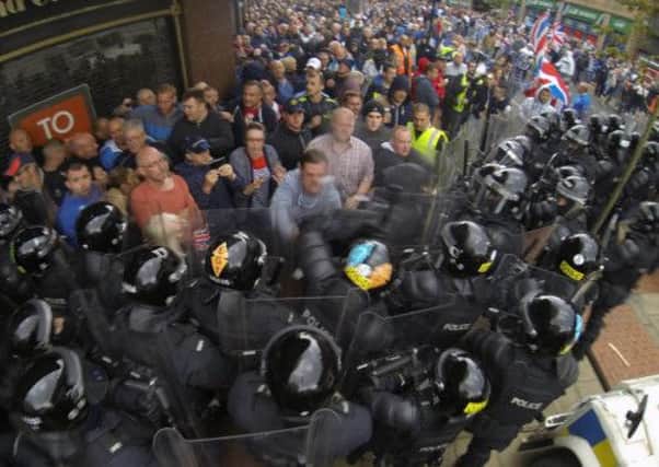 Police clash with loyalist protesters in Belfast city centre as they attempt to block part of the route of the Anti-Internment League parade on Friday. Picture: PA