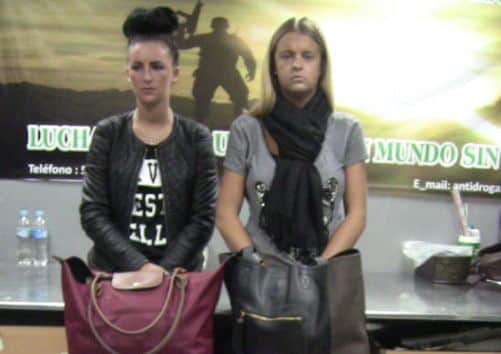 Michaella McCollum Connolly, left, and Melissa Reid, stand behind their luggage after being detained at the airport in Lima, Peru. Picture: AP