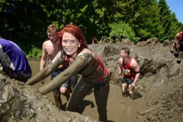 Competitors tackle the mud in a Tough Mudder in London. Picture: Complimentary