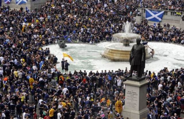 Thousands of Tartan Army footsoldiers descended on their traditional stamping ground of Trafalgar Square, even turning a fountain into a giant bubble bath by pouring washing-up liquid into it. Picture: Phil Wilkinson