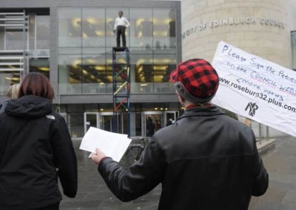 An Edinburgh council worker hands out leaflets calling for a whistleblower hotline. Picture: TSPL