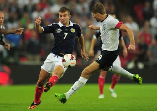 James Morrison, left, and Steven Gerrard battle for possession. Picture: Getty