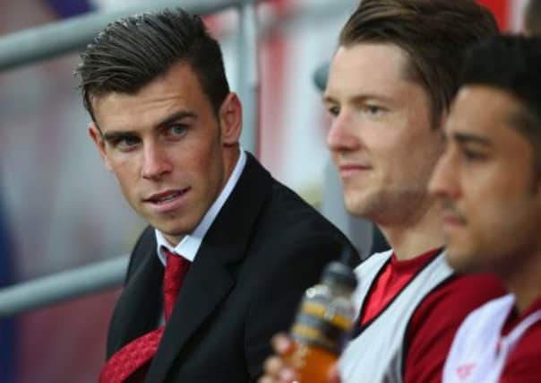 Gareth Bale looks on from the bench as Wales were held to a goalless draw. Picture: Getty