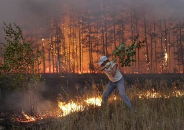 A Russian man tries to stop a fire near the village of Dolginino in 2010 during one of the country's most severe heatwave in decades. Picture: Getty