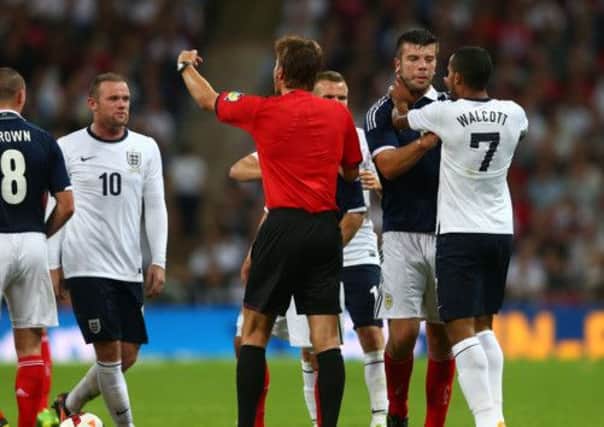 Grant Hanley confronts Theo Walcott. Picture: Getty