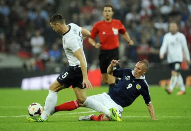Kenny Miller tackles Gary Cahill during the friendly at Wembley on Wednesday. Picture: Phil Wilkinson