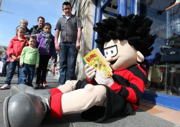 Dennis the Menace catches up on his antics in a rare issue of The Beano. Picture: PA